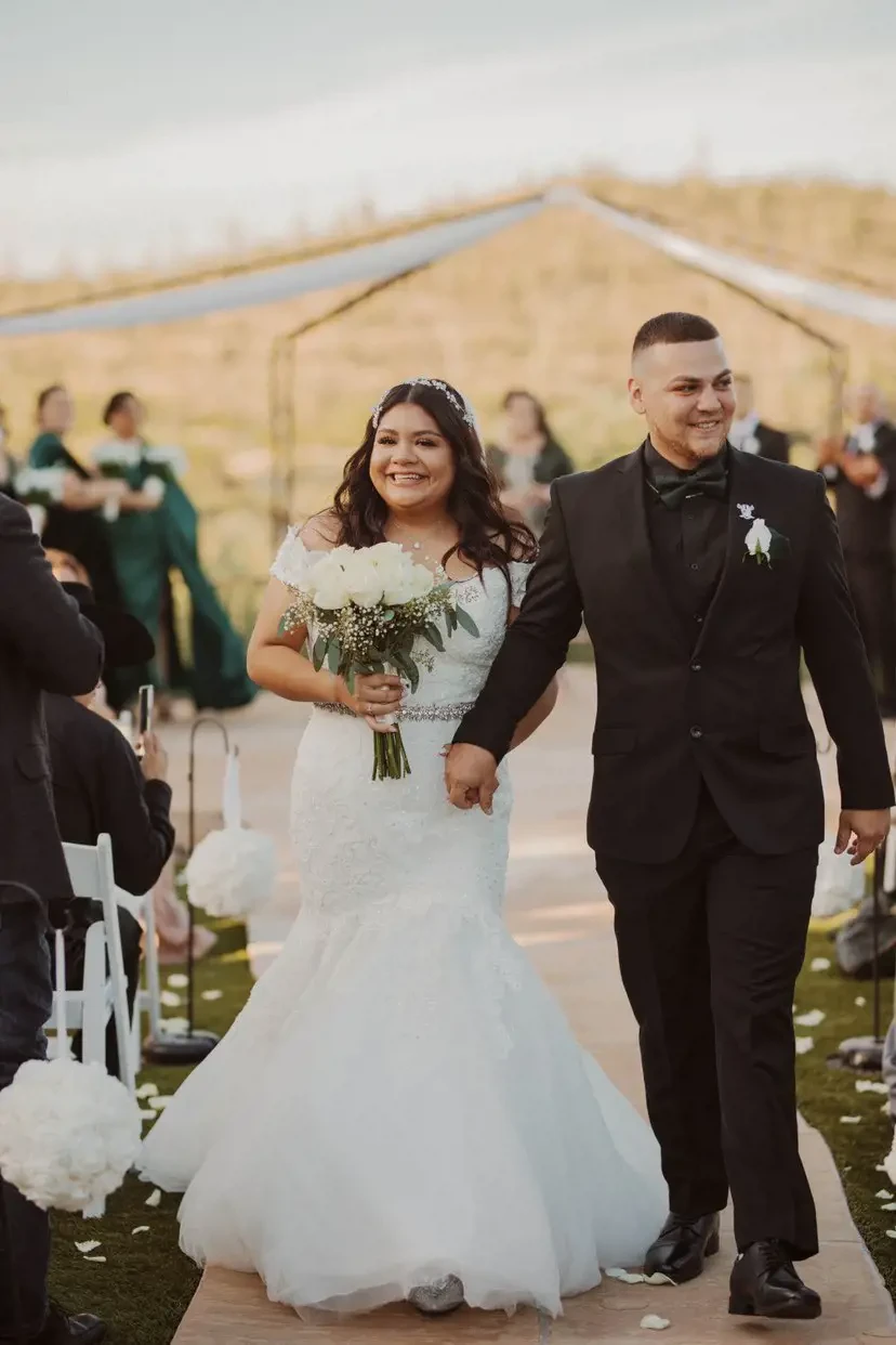 Сouple wearing a white gown and a black suit