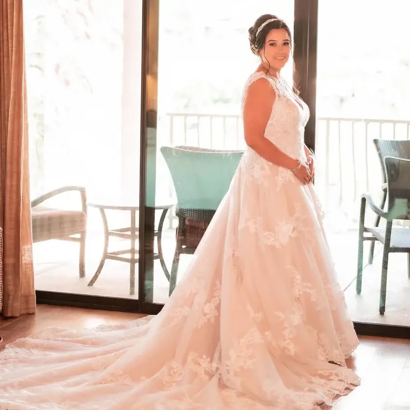 Model wearing a bridal gown at home