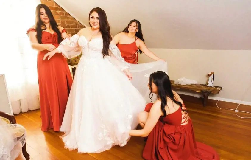 Model wearing a white gown at home