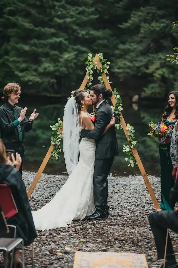 Kissing couple wearing a white gown and a black suit