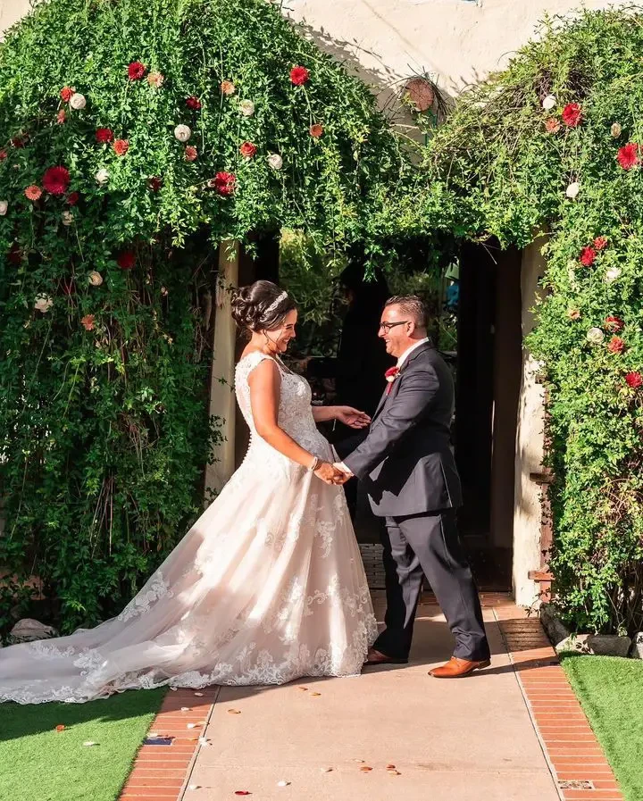 Сouple wearing a white gown and a gray suit