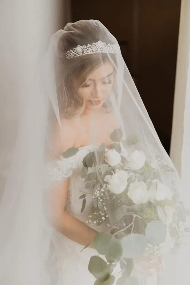 Model wearing a bridal gown with flowers
