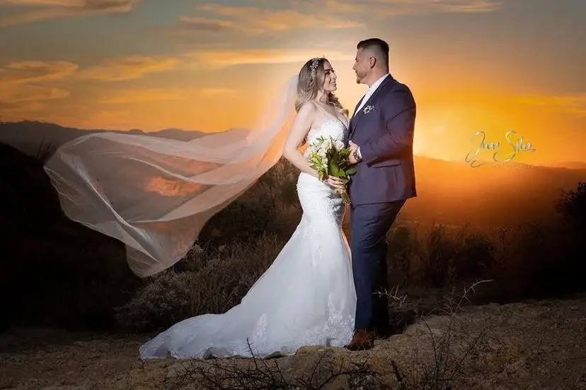 Сouple wearing a white gown and a dark-gray suit