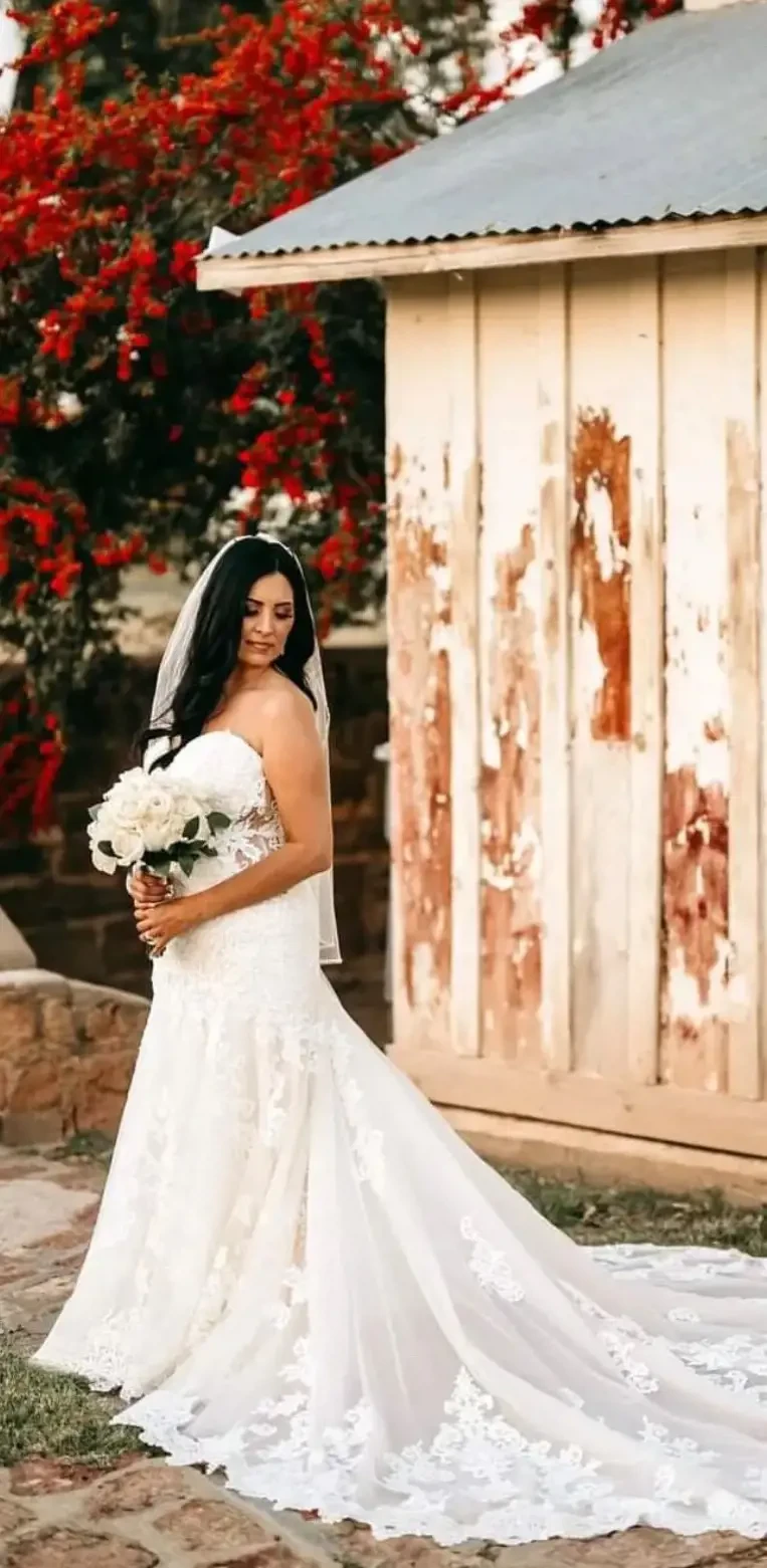 Model wearing a white gown with flowers